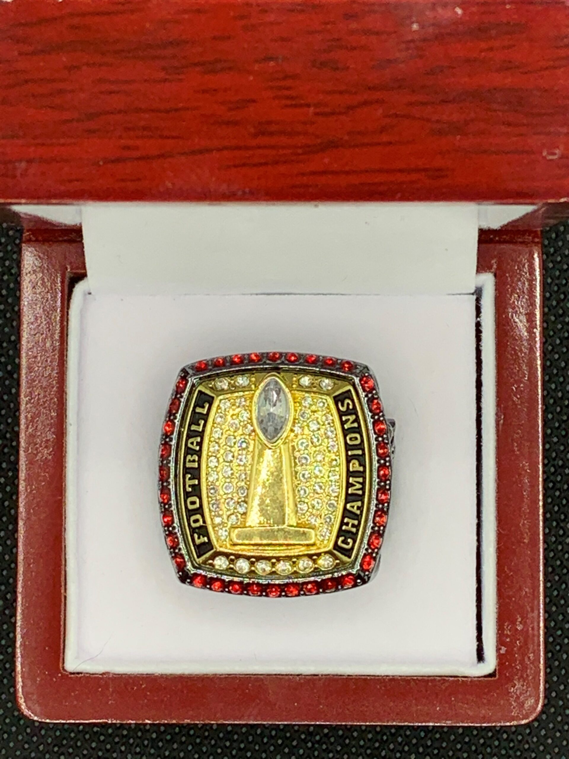 FOOTBALL CHAMPIONSHIP RING — GUNMETAL BODY, GOLD TOP, RED STONE