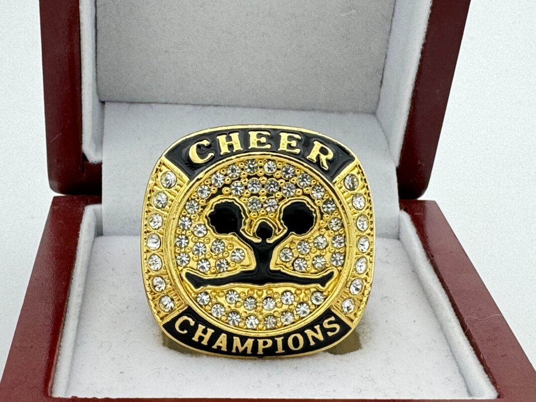 gold and black cheer championship ring with white gems