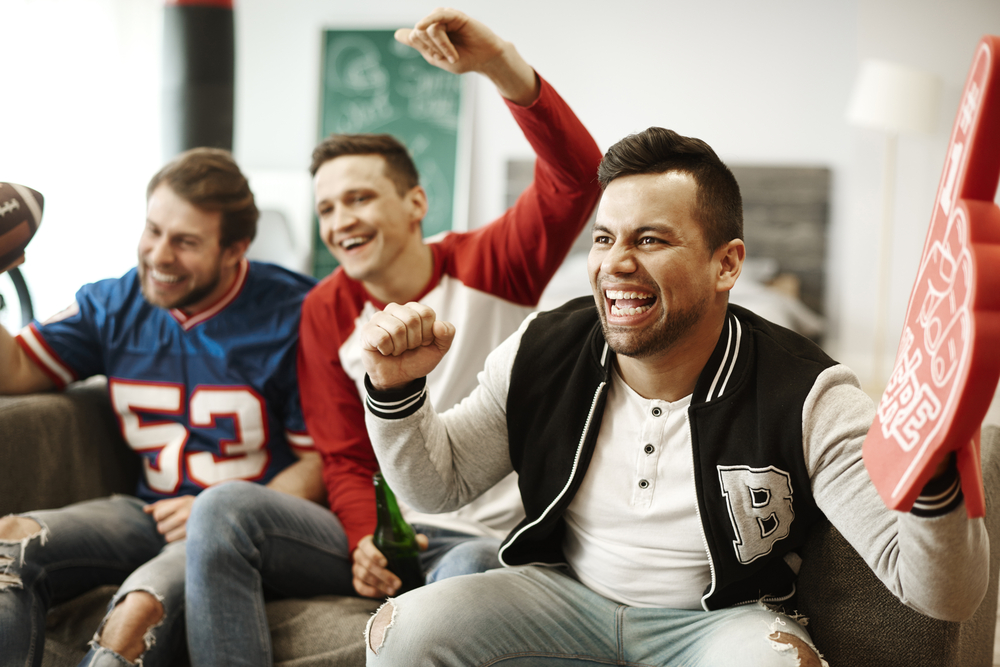 Cheerful men supporting their sport team