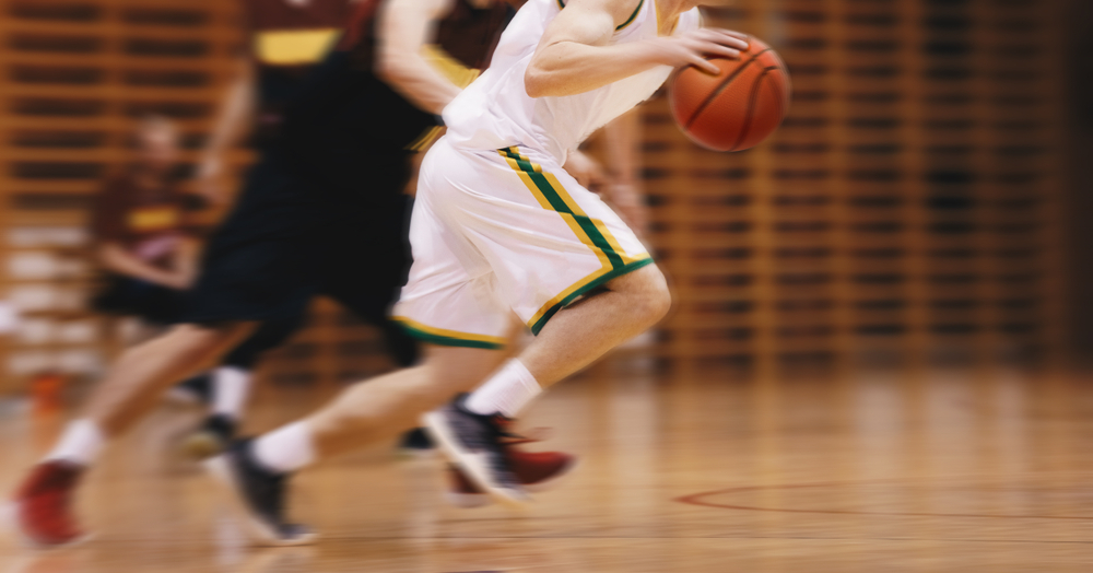 Two Young High School Basketball Players Playing Game