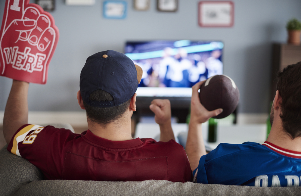 Two men with foam hand and baseball equipment