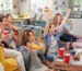 Diverse mix of friends sports fans watching winning football match on TV