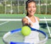 How Championship Rings Can Motivate Teams to Victory. Tennis player portrait. Woman showing tennis ball and racket smiling happy. Female athlete inviting you to play tennis. Healthy active sport and fitness lifestyle concept outdoor.