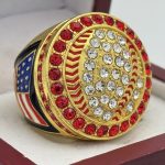ROUND BALL RING --- RED STONES ON EDGES, GOLD BODY, CLEAR STONES ON THE BALL (Item #30-165)