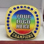ROUND ADD YOUR LOGO CHAMPION RING --- GOLD BODY, BLUE STONES, 2 ENGRAVABLE SIDES (Item #58-172) - Image 3